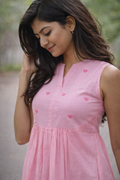 Woman wearing a pink dress with heart patterns outdoors